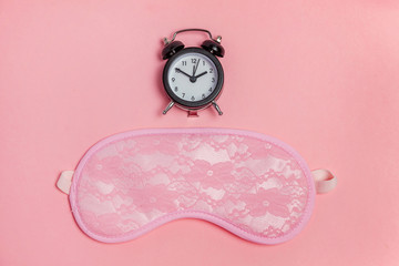 Sleeping eye mask, alarm clock isolated on pink pastel colourful trendy background. Do not disturb...