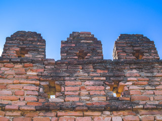 Fototapeta na wymiar Old red brick wall against the sky