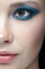 Closeup macro portrait of female face. Human woman half-face  with evening beauty makeup.