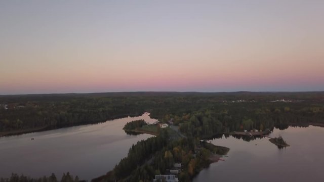 Aerial view of a Beautiful Sandy Beach on the Atlantic Ocean Coast during a vibrant sunrise. Taken near in Pabos Mills, Quebec, Canada.