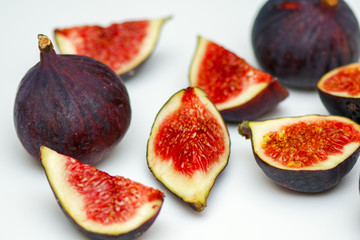 Figs whole and in pieces - fresh, juicy, tasty, sweet on a white background. macro