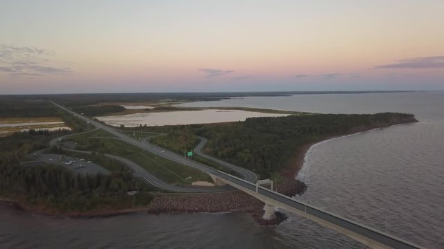 Aerial view of a Beautiful Sandy Beach on the Atlantic Ocean Coast during a vibrant sunrise. Taken near in Pabos Mills, Quebec, Canada.
