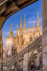 Fotobehang Vertical: Sunset exterior rooftop view fo Duomo di Milano with spires, blue sky, and architectural details © skyoftexas
