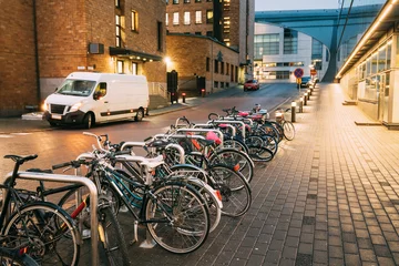 Fotobehang Helsinki, Finland. Bicycles Parked Near Storefronts In Postgrand © Grigory Bruev