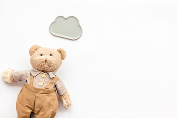 Toys for newborn baby set with teddy bear and clouds on white background flat lay space for text