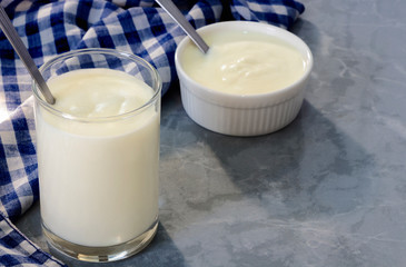 Two cups of yogurt a healthy breakfast. Yogurt made from milk fermented by added bacteria, often sweetened and flavored.