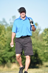 Fototapeta premium Golfer With Golf Club Walking