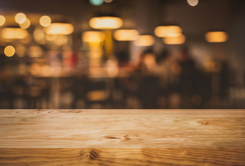 Wood texture table top (counter bar) with blur light gold bokeh in cafe,restaurant background.For montage product display or design key visual