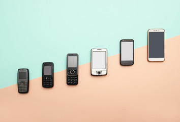 evolution of cell phones. Technology development telephone and pda concept. Vintage and new phones. Top view. Telephone communication progress, mobile classic device .