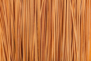 Dry buckwheat noodles texture, shot from the top. Soba background