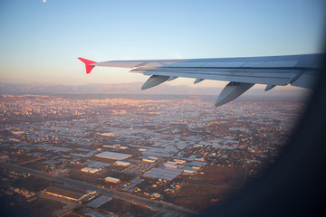 Fototapeta premium City panorama from height of bird's flight. A view of the city from a plane window.