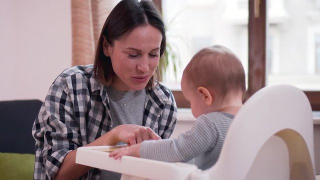 Mother with baby girl in highchair