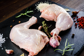 Raw chicken legs on wooden background