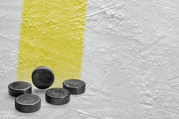 Fototapeta premium Washers and ice arena fragment with yellow line