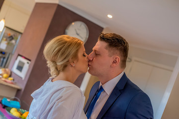 Bride and groom kissing before going at theirs wedding.