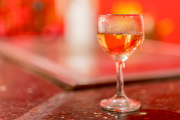 Wine glass on blurred background. Glass with white wine on table. copy space.