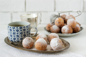 Vanilla krapfen doghnut with coffee. Rustic style.