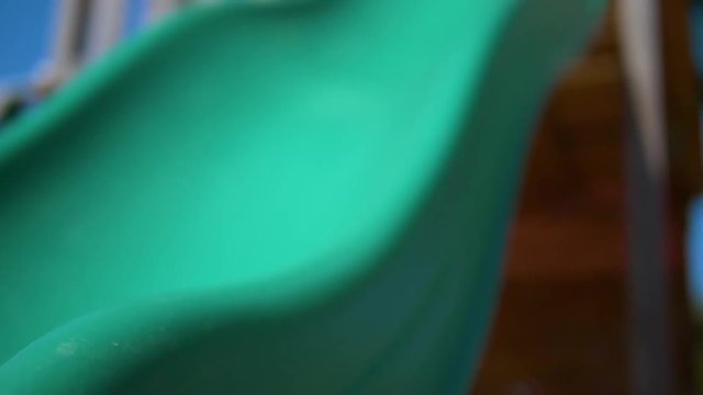 Girl going down a children&rsquo;s slide in a children&rsquo;s playground Slow motion video of a girl/child/kid/baby going down a slide in a children&rsquo;s playground