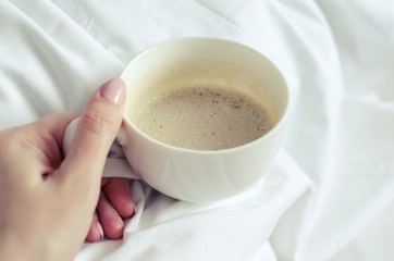 A cup of coffee in hand