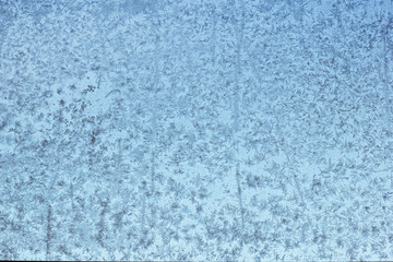 Fototapeta na wymiar Beautiful ice patterns on the window