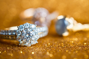 Jewelry diamond ring with abstract festive glitter Christmas holiday texture background blur with bokeh light