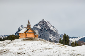 Small wooden church with Grosser Mythen peak in bacgkround in Stoos