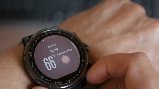 Closeup of black smart watch with weather app Using a smart watch to check the weather forecast directly on the wrist.