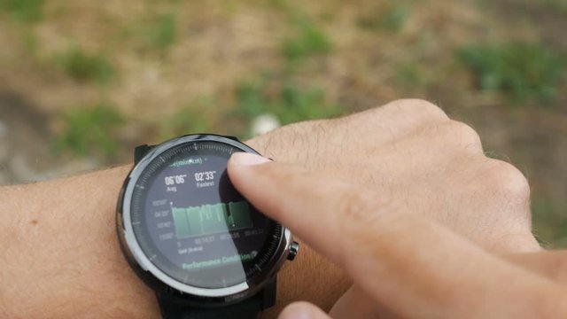 Results of a running training session on smart watch. Smartwatch. Hand with sports watch which shows results of training. Pulse, speed, distance, calories