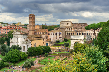 Fototapeta na wymiar Colosseum and Ruins of Roman Forum. Santa Francesca Romana church, Arch of Titus and others. Rome. Italy