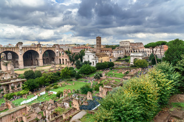 Fototapeta na wymiar Ruins of Roman Forum. Temple of Antoninus and Faustina, basilica of Santi Cosma e Damiano and others. Rome. Italy