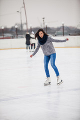 Skates on the rink. Woman on the ice