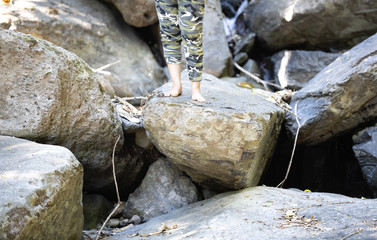 woman standing on rocky