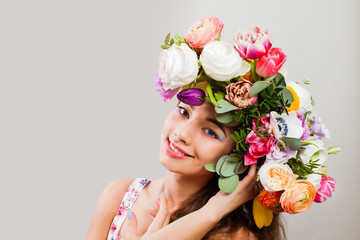 Beauty Summer model girl with colorful flowers wreath and Fashion Makeup