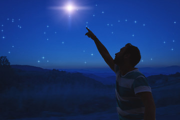 Man pointing at the starry night sky. Elements of this image are my work.