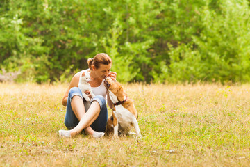 Animal lover sitting outside with her pets