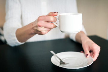 morning Cup of tea in the hands of a young woman