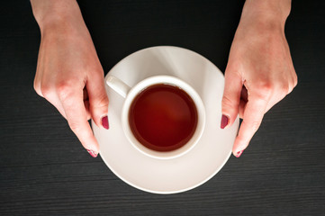 morning Cup of tea in the hands of a young woman