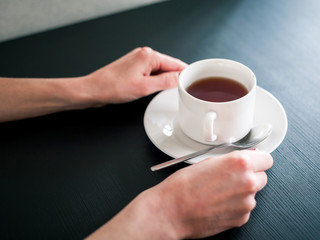 morning Cup of tea in the hands of a young woman