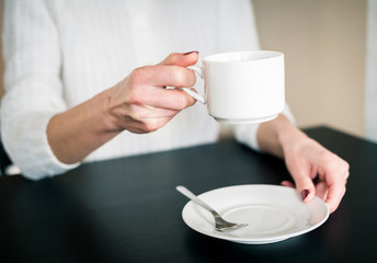 morning Cup of tea in the hands of a young woman