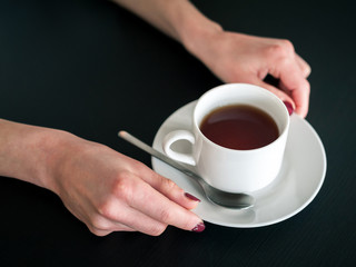 morning Cup of tea in the hands of a young woman