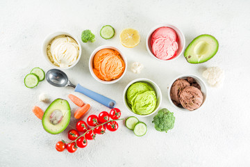 Trendy vegan food, summer healthy dessert concept, colorful diet vegetable ice cream with avocado, cucumber, tomato, beet, carrot, broccoli, cauliflower. Frozen veggie smoothie,  banner