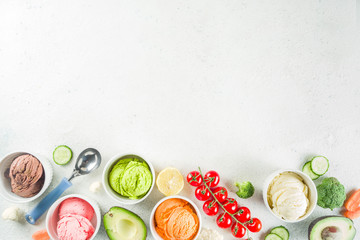 Trendy vegan food, summer healthy dessert concept, colorful diet vegetable ice cream with avocado, cucumber, tomato, beet, carrot, broccoli, cauliflower. Frozen veggie smoothie,  banner