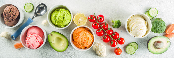 Trendy vegan food, summer healthy dessert concept, colorful diet vegetable ice cream with avocado, cucumber, tomato, beet, carrot, broccoli, cauliflower. Frozen veggie smoothie,  banner