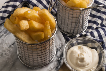french fries in a serving basket, served with mayonnaise