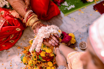 Indian couples holding hands in their wedding ceremoney.