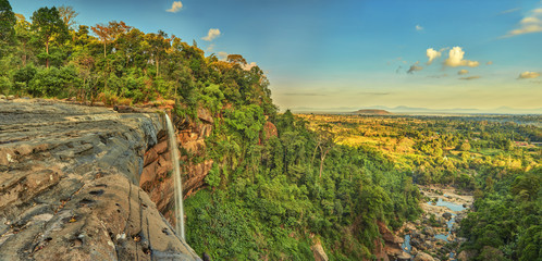 Beautiful waterfall flowing from the cliff in the tropical jungles panoramic top view