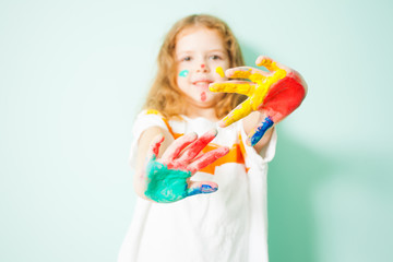 Smiling girl showing her painted palms on camera