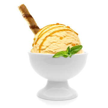 Vanilla ice cream scoop with wafer stick and caramel syrup, sauce or sherbet in bowl isolated on white background