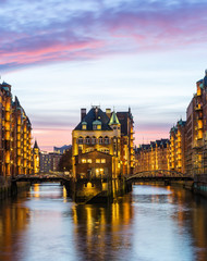 Hamburg Speicherstadt (warehouse district) in the evening, colorful with Watercastle (Wasserschloss)
