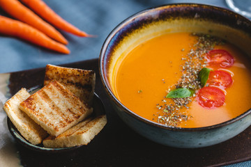 lentil soup with bread and herbs on the table. soup puree